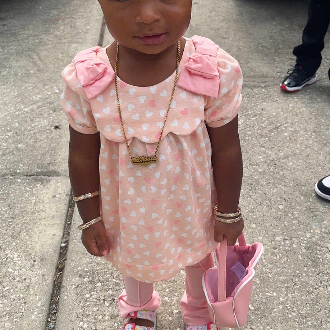 Deinovia joined the competition — help win amazing prizes! accessories, bracelets, casual, child, concrete, curly_hair, fashion, footwear, heart_pattern, necklace, outdoor, person, pink_clothing, purse, sandals, sidewalk, standing, street, toddler, vehicle