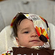 Siul joined the competition — help win amazing prizes! baby, child, face, cloth, colorful, turkey, pattern, brown_clothing, text, sitting, chair, portrait, infant, cute, indoors, comfort, young, expression, head, closeup