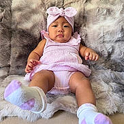 Elara Lucynn is registered to the contest to win money with this photo: baby, infant, child, pink_outfit, headband, sock, fluffy_blanket, soft_texture, cute, portrait, indoor, relaxed, looking_at_camera, small_hands, small_feet, comfortable, seated, playful, young, adorable