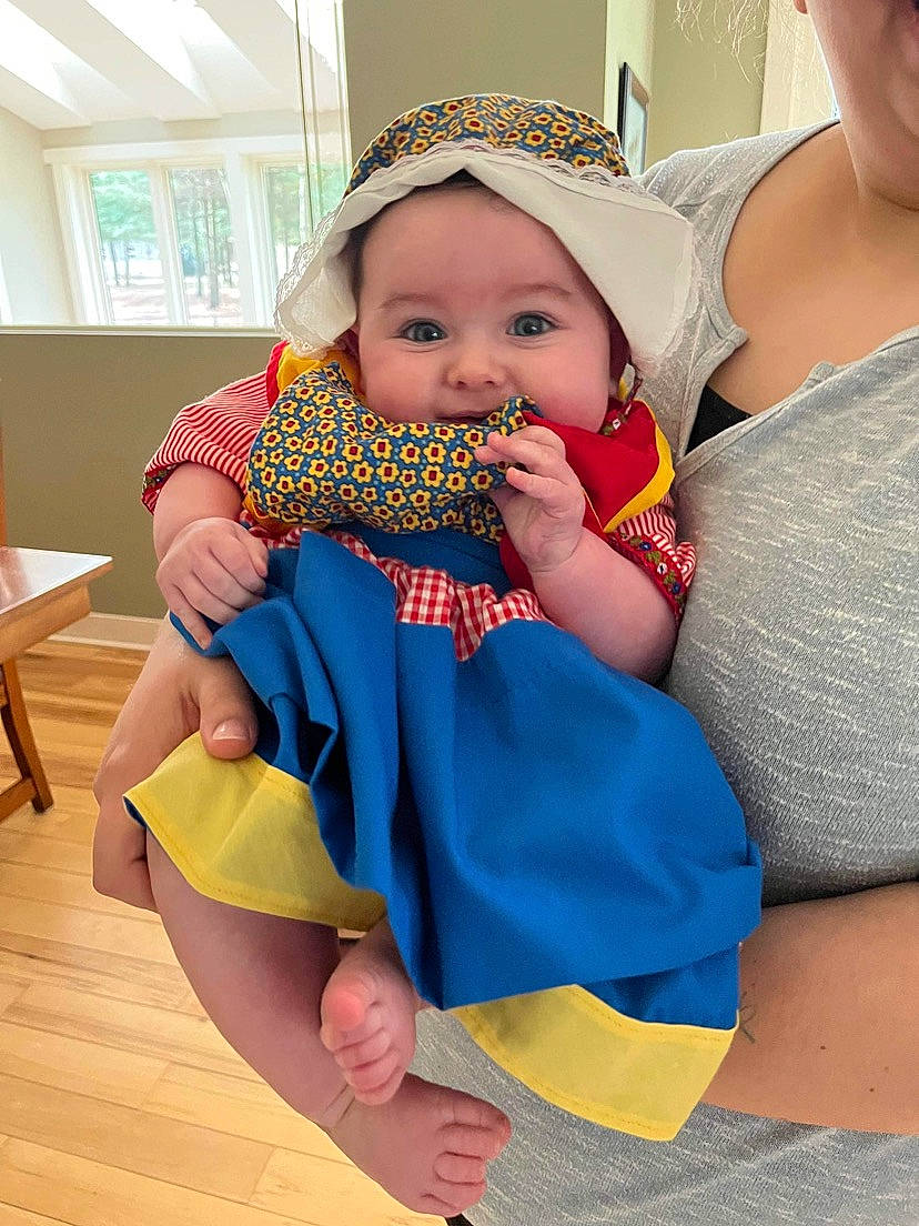 Ophelia is registered to the contest to win money with this photo: arm, azure, baby, baby_products, baby_toddler_clothing, child, electric_blue, finger, fun, hand, happy, headwear, joint, nail, pattern, person, skin, sleeve, thigh, toddler