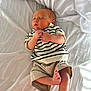 newborn, baby, sleeping, infant, striped_shirt, shorts, bed, white_sheet, peaceful, hands, feet, skin, clothing, rest, cute, portrait, indoors, soft_light, child, relaxation