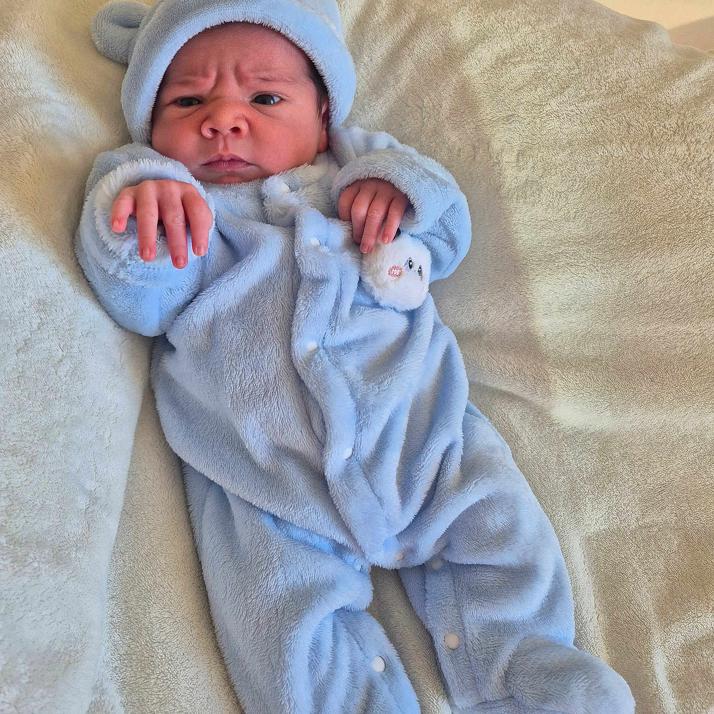Duarte participe au concours pour gagner de l'argent avec cette photo : baby, bear_ears, blanket, blue_onesie, child, clothing, cozy, cute, expression, face, footed_pajamas, hand, indoors, infant, newborn, portrait, resting, sleepwear, soft_texture, warm