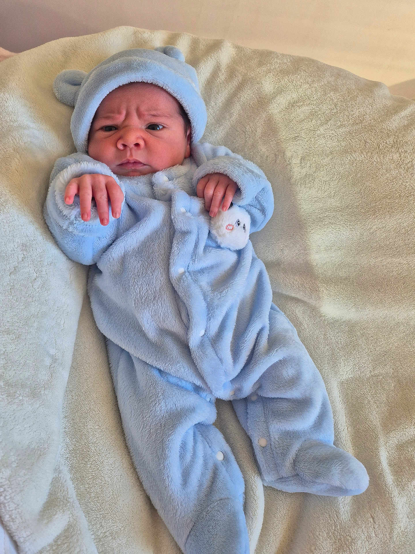 Duarte participe au concours pour gagner de l'argent avec cette photo : baby, bear_ears, blanket, blue_onesie, child, clothing, cozy, cute, expression, face, footed_pajamas, hand, indoors, infant, newborn, portrait, resting, sleepwear, soft_texture, warm