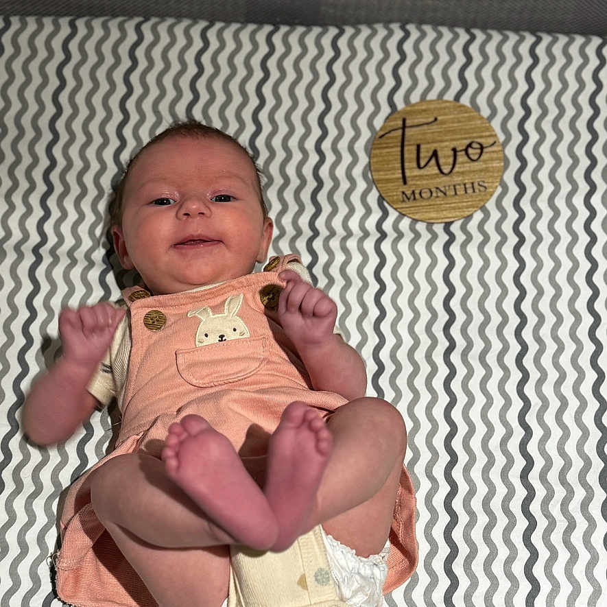 Maevis joined the competition — help win amazing prizes! baby, bed, bedroom, bodypart, clothing, crib, diaper, face, finger, furniture, glove, hand, head, homedecor, infantbed, newborn, person, photography, portrait, sitting