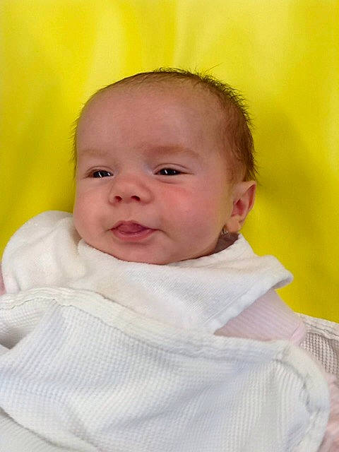 Henley is registered to the contest to win money with this photo: baby, beauty, cheek, child, chin, close_up, eye, face, facial_expression, head, iris, lip, mouth, nose, person, pink, skin, smile, toddler, yellow