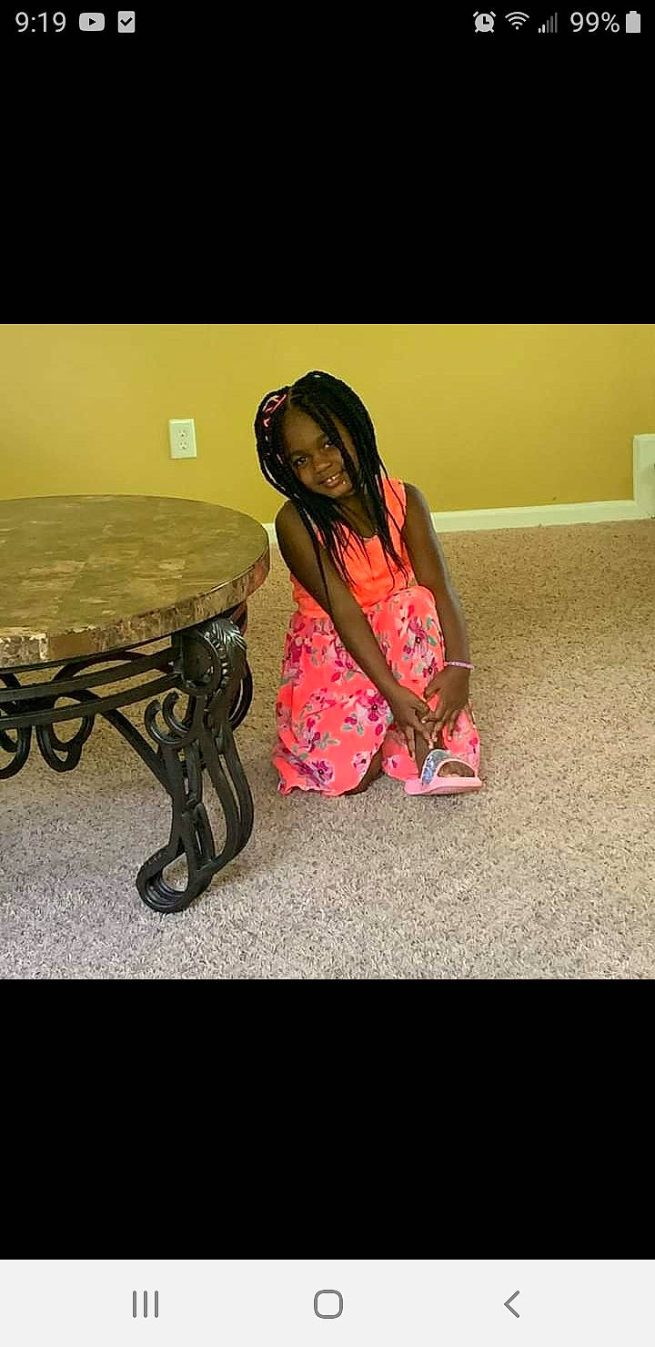 Cassidy joined the competition — help win amazing prizes! black_hair, furniture, joy, leg, long_hair, person, photography, pink, sitting, smile, table