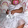 Ena joined the competition — help win amazing prizes! baby, sleeping, pacifier, tutu, white_clothing, headband, bow, blanket, rainbow_pattern, sock, infant, cute, tulle, soft, child, comfort, rest, indoors, person, portrait