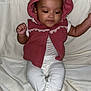 baby, child, infant, hooded_vest, maroon_clothing, lace_trim, white_pants, sitting, barefoot, indoors, fabric_backdrop, cute, calm, curious, skin, face, hands, foot, portrait, person