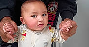 Karsen is registered to the contest to win money with this photo: baby, child, onesie, winnie_the_pooh, person, hands, indoor, door, clothing, adult, supporting, walking, curious, standing, sleeves, floor, footwear, hoodie, logo, skin