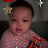 baby, cherries, child, closeup, curious, cute, digital_stickers, face, hand, indoor, leopard_print, lipstick_kiss, patterned_clothing, person, pink_clothing, portrait, red_bow, soft_lighting, stars, young_child