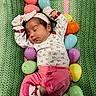 baby, newborn, sleeping, pink_clothing, headband, mittens, easter_eggs, green_blanket, knit_blanket, holiday, easter, colorful, cute, infant, resting, soft, cozy, child, sleep, festive