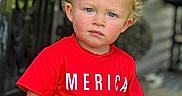 Beckham joined the competition — help win amazing prizes! background_blur, blonde_hair, blue_eyes, child, curly_hair, daylight, face, hand_on_chair, outdoor, patterned_pants, person, porch, red_shirt, serious_expression, short_sleeves, skin, standing, text_on_clothing, toddler, young_child