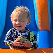 Beckham joined the competition — help win amazing prizes! toddler, child, smile, ball, curly_hair, outdoor, inflatable, blue, orange, sunlight, play, fun, happy, young_child, colorful, clothing, person, summer, water, toy