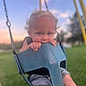 Beckham joined the competition — help win amazing prizes! baby, blue_swing, casual_clothing, child, curly_hair, cute, daylight, fun, grass, holding, outdoor, park, playground, portrait, sky, smiling, sunset, swing, toddler, young_child