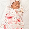 Sophia is registered to the contest to win money with this photo: newborn, baby, sleeping, infant, swaddled, blanket, pink, hat, bow, cute, soft, white_background, peaceful, wrapped, child, portrait, indoors, resting, cozy, newborn_baby
