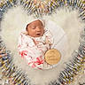 newborn, baby, sleeping, blanket, personalized, wooden_plaque, name, heart_shape, syringes, vaccine_vials, medical, protection, care, fluffy_background, infant, wrapped, closeup, health, safe, peaceful