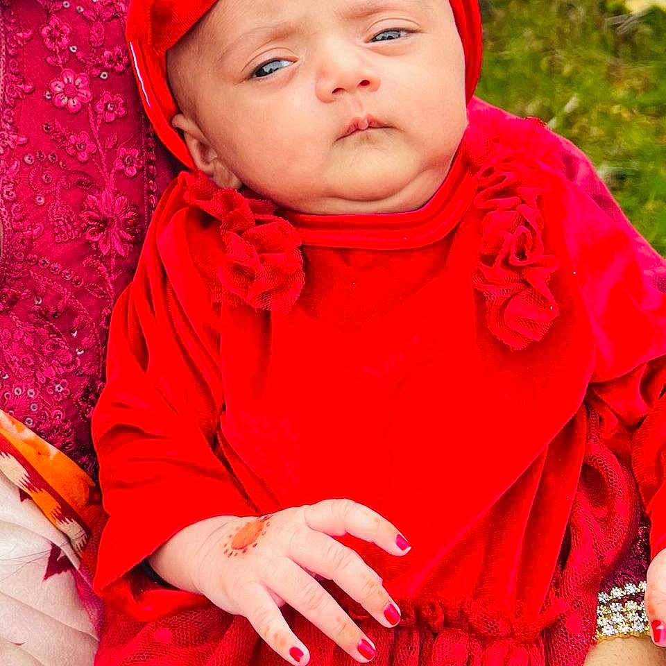Mahveen Zahra is registered to the contest to win money with this photo: accessories, baby, bodypart, bonnet, clothing, coat, dress, face, finger, flower, hand, hat, head, hood, jewelry, people, person, photography, plant, portrait