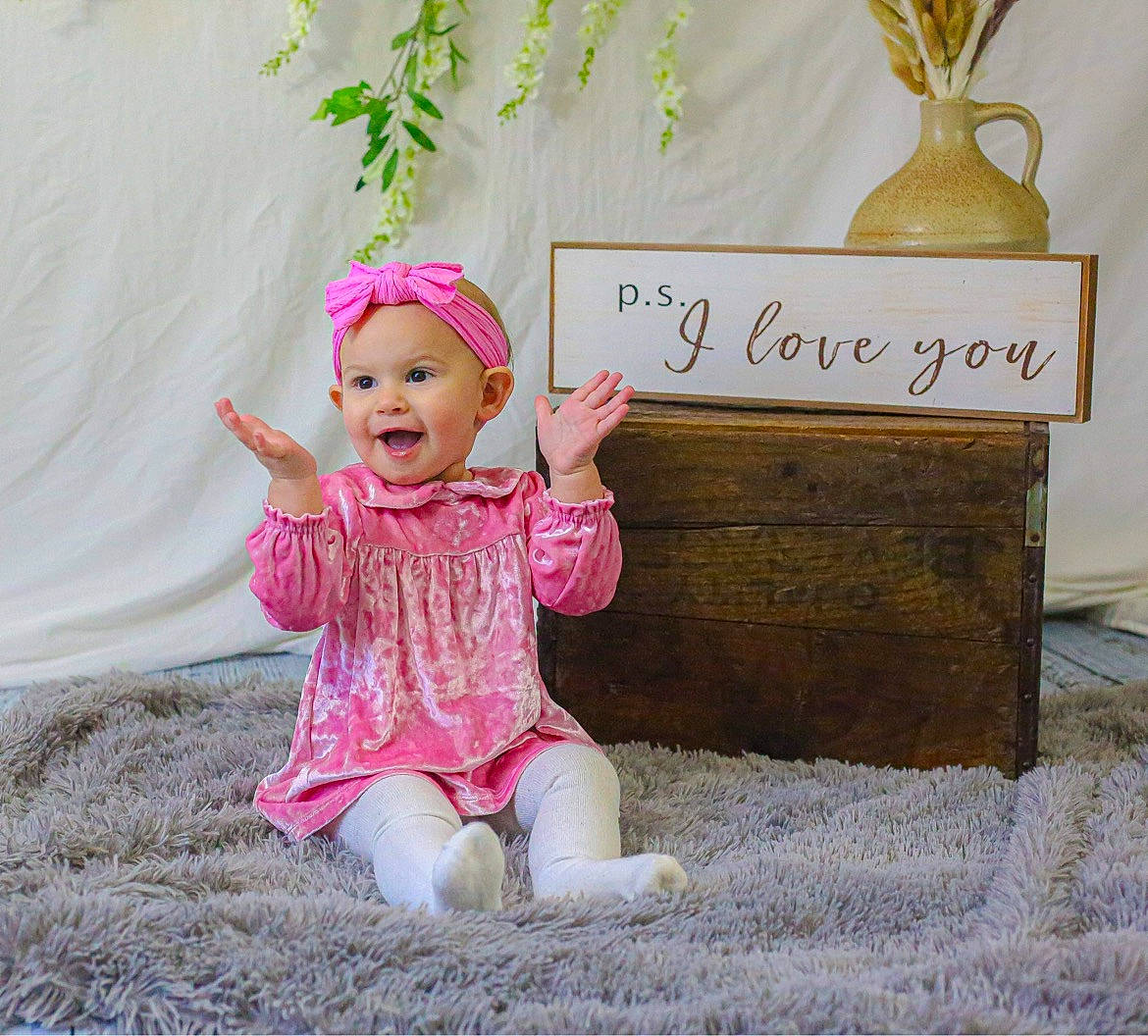 Hartlyn Ruth is registered to the contest to win money with this photo: baby, baby_toddler_clothing, child, fashion_accessory, font, fun, grass, handwriting, happy, headwear, leaf, logo, magenta, paper_product, people_in_nature, person, pink, portrait_photography, product, sitting