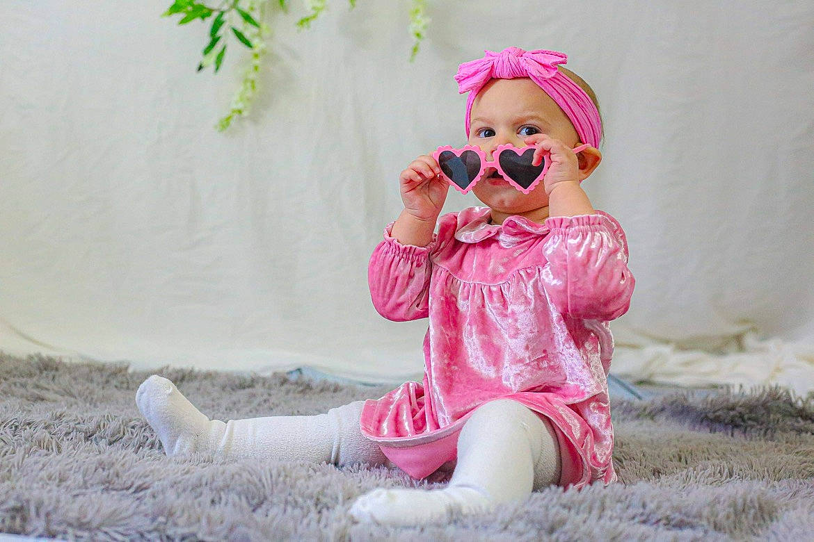 Hartlyn Ruth joined the competition — help win amazing prizes! baby_toddler_clothing, cap, child, dress, eyewear, facial_expression, goggles, grass, happy, hat, leisure, lip, magenta, person, pink, plant, skin, sunglasses, textile, toddler