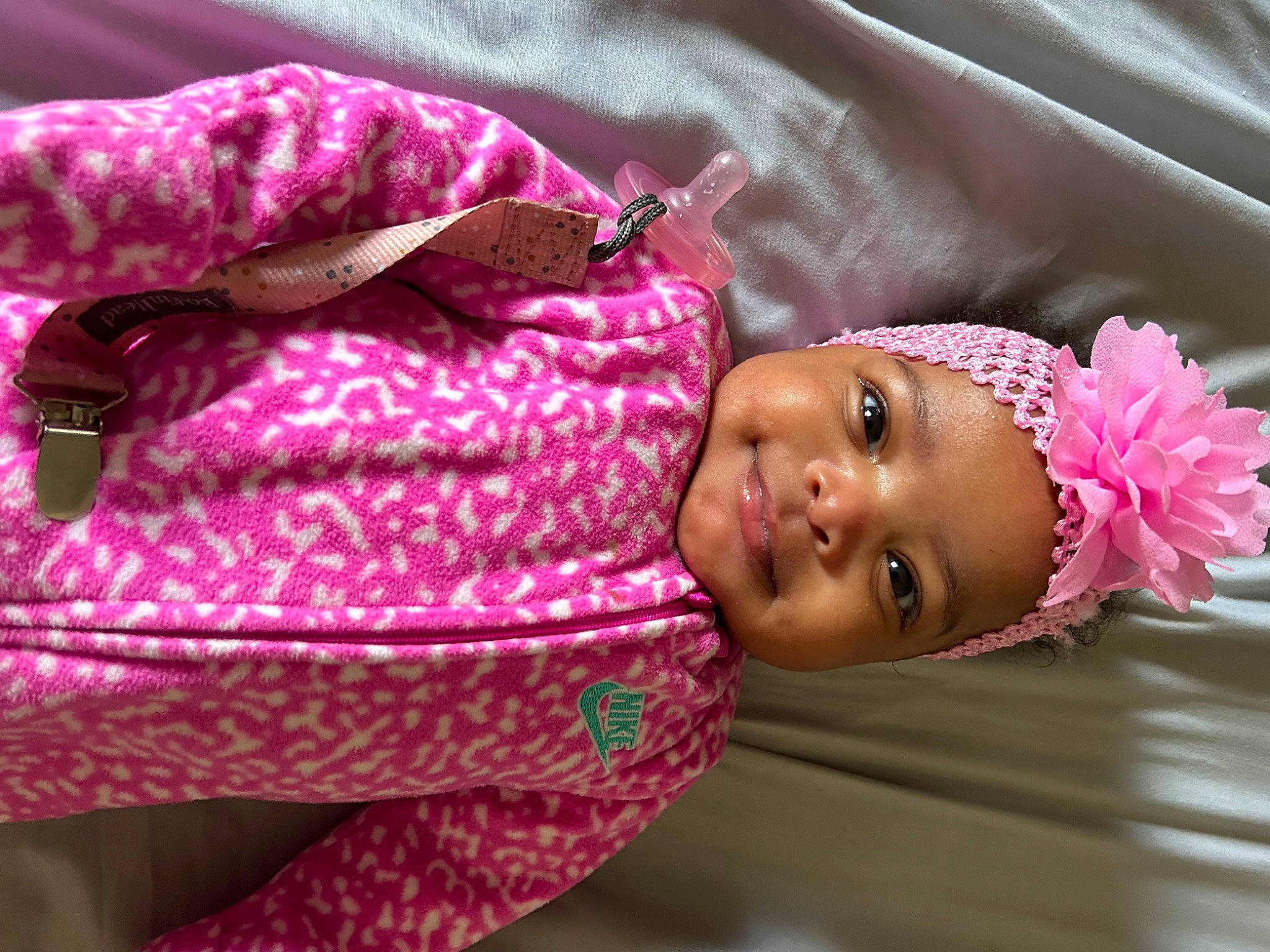 Jaylani joined the competition — help win amazing prizes! baby, baby_toddler_clothing, cheek, child, comfort, eyelash, facial_expression, happy, headwear, linens, lip, magenta, nose, person, pink, purple, skin, sleeve, smile, textile