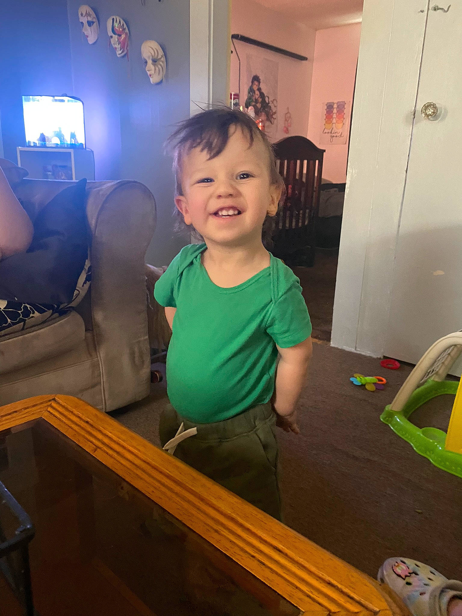 Alexander is registered to the contest to win money with this photo: baby, baby_toddler_clothing, chair, child, couch, door, floor, flooring, fun, happy, hardwood, joy, person, picture_frame, room, sitting, smile, standing, t_shirt, television