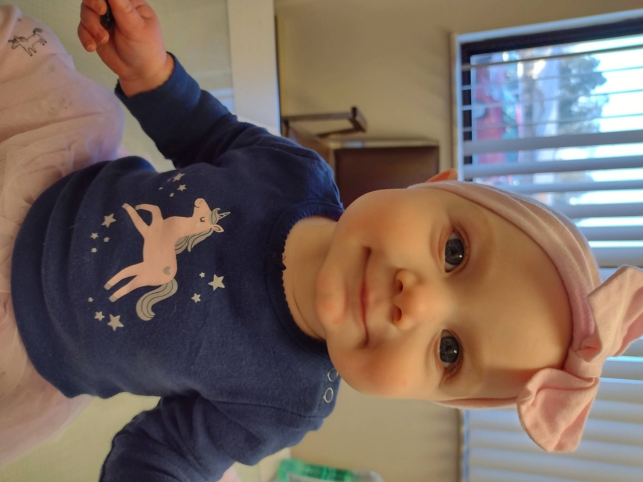 Elaina is registered to the contest to win money with this photo: baby, baby_toddler_clothing, cheek, child, eyelash, gesture, happy, headwear, home_appliance, joy, mouth, nose, person, skin, sleeve, smile, t_shirt, television, thumb, toddler