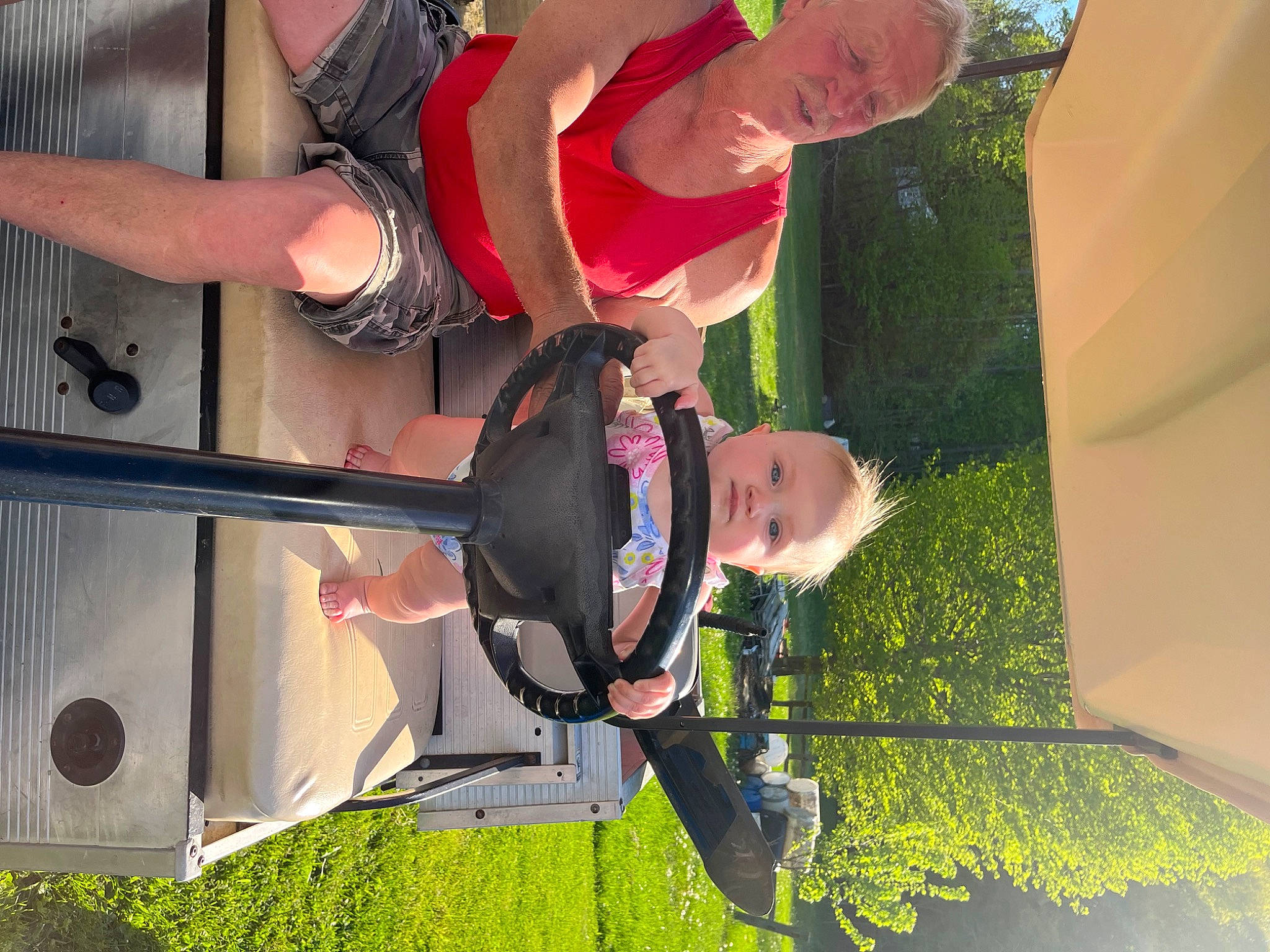 London is registered to the contest to win money with this photo: adventure, elbow, event, fun, grass, hat, human_leg, leisure, person, plant, recreation, red, thigh, tree