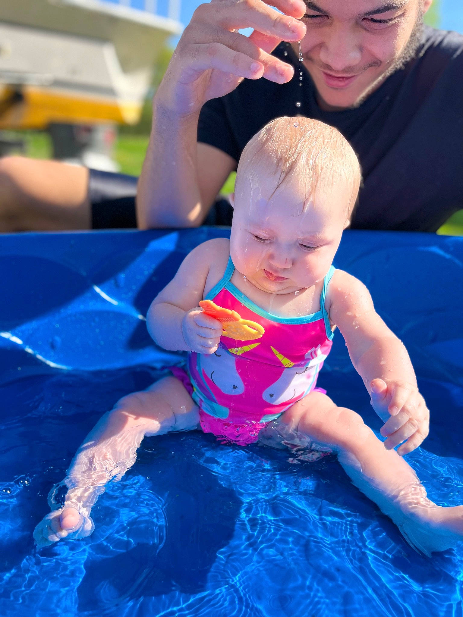 London is registered to the contest to win money with this photo: azure, baby, blue, child, electric_blue, event, fun, happy, headwear, joy, leisure, people, person, personal_protective_equipment, photograph, play, recreation, shorts, summer, swimming_pool