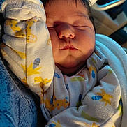 Ashlynn joined the competition — help win amazing prizes! baby, sleeping, onesie, infant, cozy, cute, child, peaceful, soft, warm_light, animal_print, hand, face, portrait, newborn, clothing, indoors, resting, cute_baby, toddler