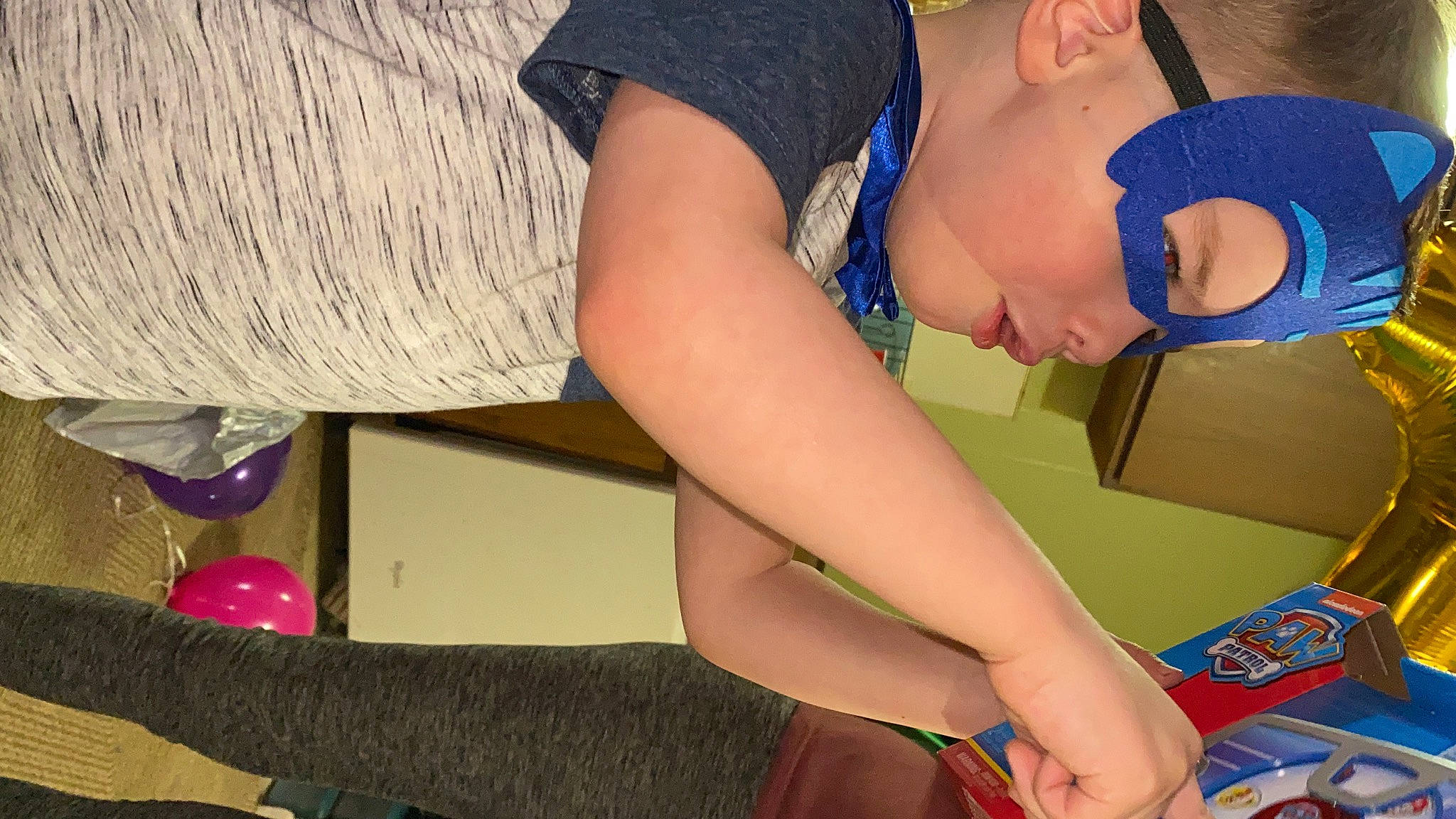 Micah is registered to the contest to win money with this photo: balloon, child, elbow, electric_blue, finger, flooring, fun, hat, headwear, human_body, human_leg, joint, knee, leisure, mouth, nail, neck, person, t_shirt, thigh