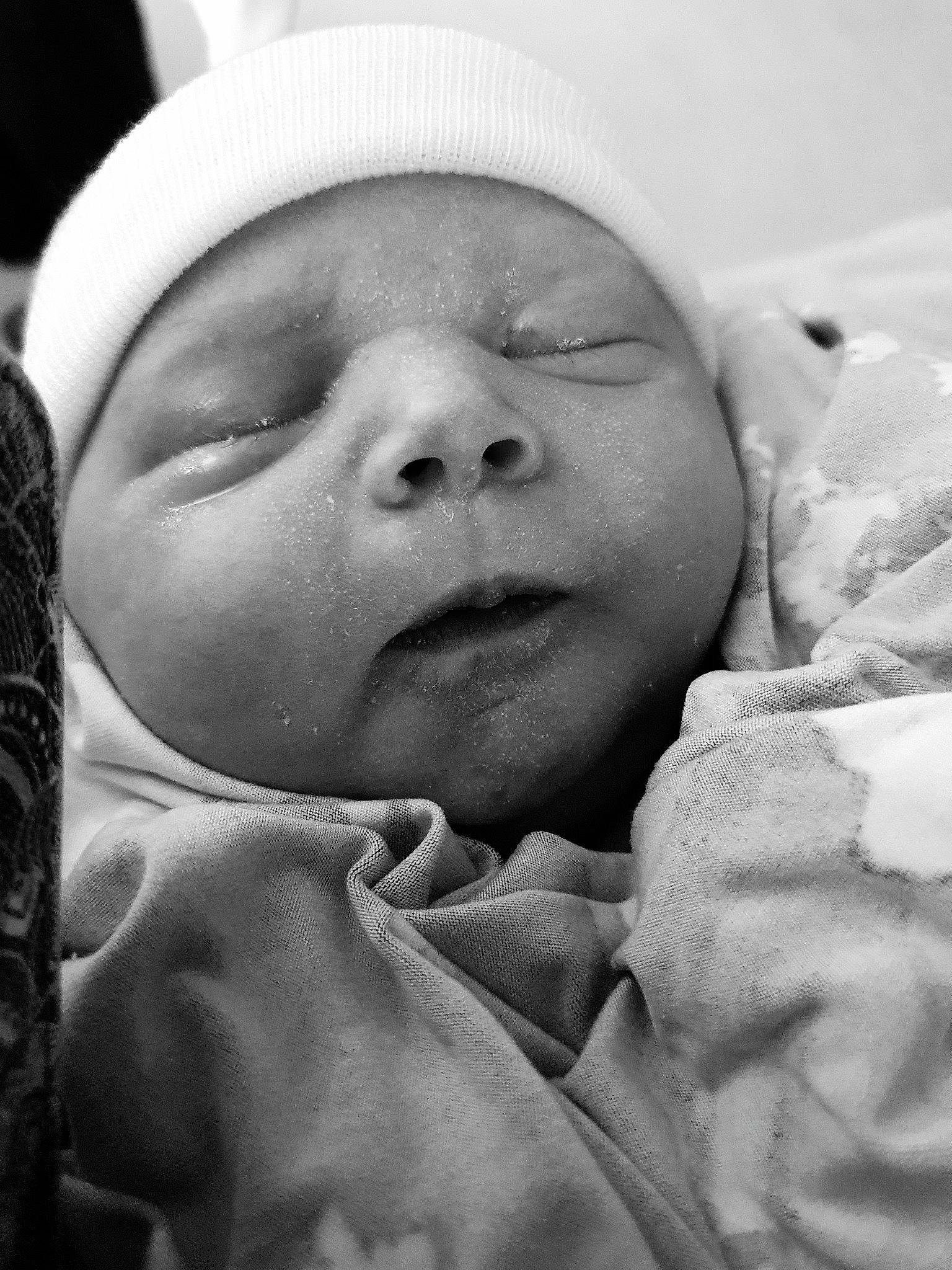 Talia is registered to the contest to win money with this photo: baby, birth, black_and_white, cheek, child, eye, face, facial_expression, head, lip, monochrome, mouth, nose, person, photography, skin, sleep, smile, toddler