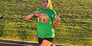 Ada-grace is registered to the contest to win money with this photo: child, girl, green_tshirt, bobcats, peace_sign, pose, running_track, grass, outdoor, sunlight, sportswear, white_shoes, youth, active, balance, cheerleader_bow, casual_clothing, summer, athletic, portrait
