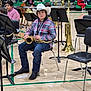 Elisha joined the competition — help win amazing prizes! child, boy, cowboy_hat, saxophone, musical_instrument, band, gymnasium, chair, music_stand, plaid_shirt, jeans, boots, children, people, indoors, performance, holiday_hat, tuba, trombone, floor