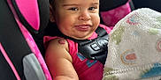Alaiah joined the competition — help win amazing prizes! baby, child, car_seat, pink_bow, blanket, smile, seatbelt, infant, cute, indoors, child_safety, car_interior, clothing, person, portrait, baby_girl, happy, seat, comfort, playful
