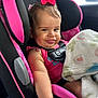 baby, child, car_seat, pink_bow, blanket, smile, seatbelt, infant, cute, indoors, child_safety, car_interior, clothing, person, portrait, baby_girl, happy, seat, comfort, playful
