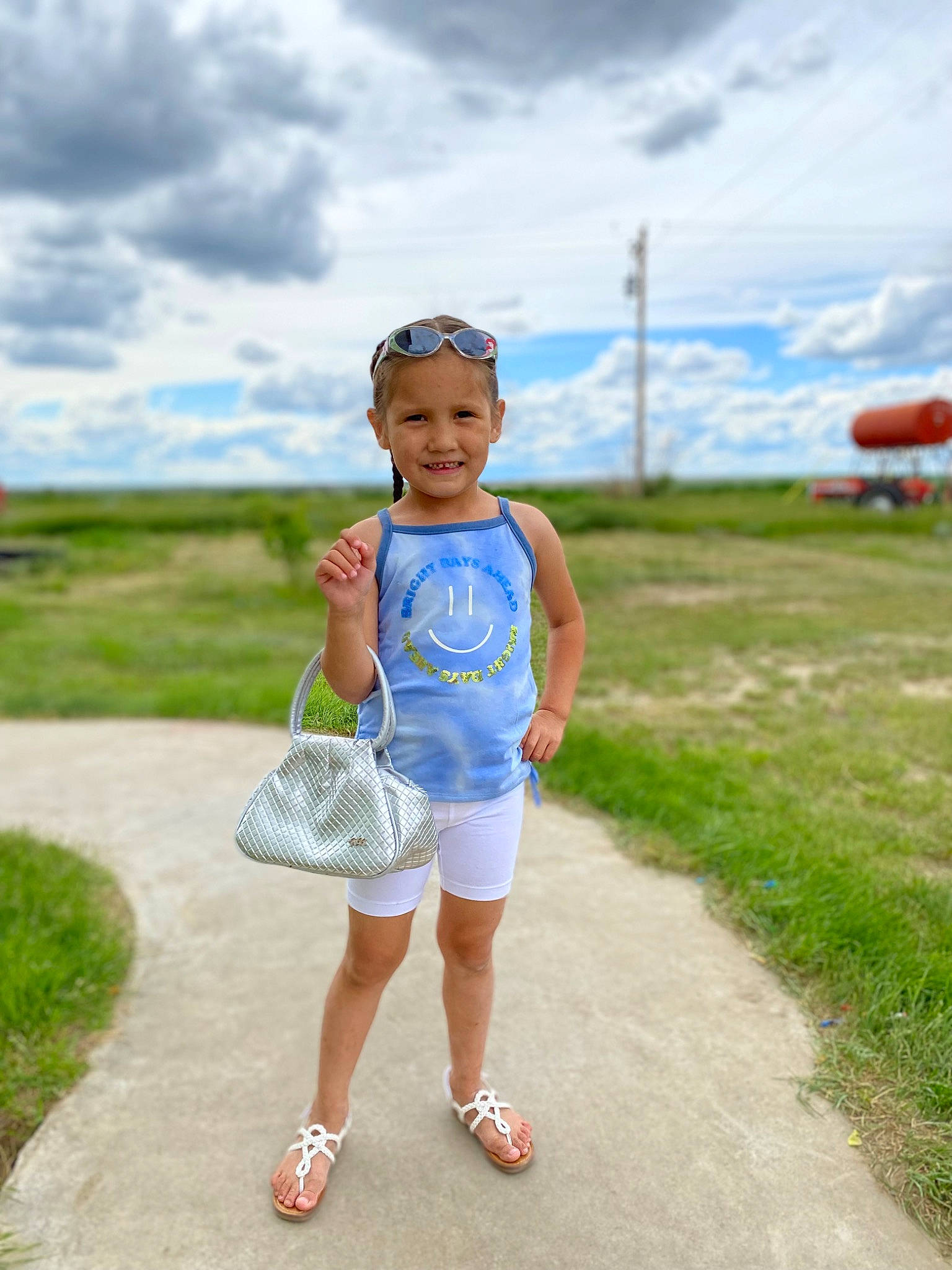 Kimberly is registered to the contest to win money with this photo: asphalt, child, cloud, electric_blue, flash_photography, fun, grass, grassland, happy, headwear, joy, landscape, leisure, people_in_nature, person, recreation, road, shorts, sky, smile