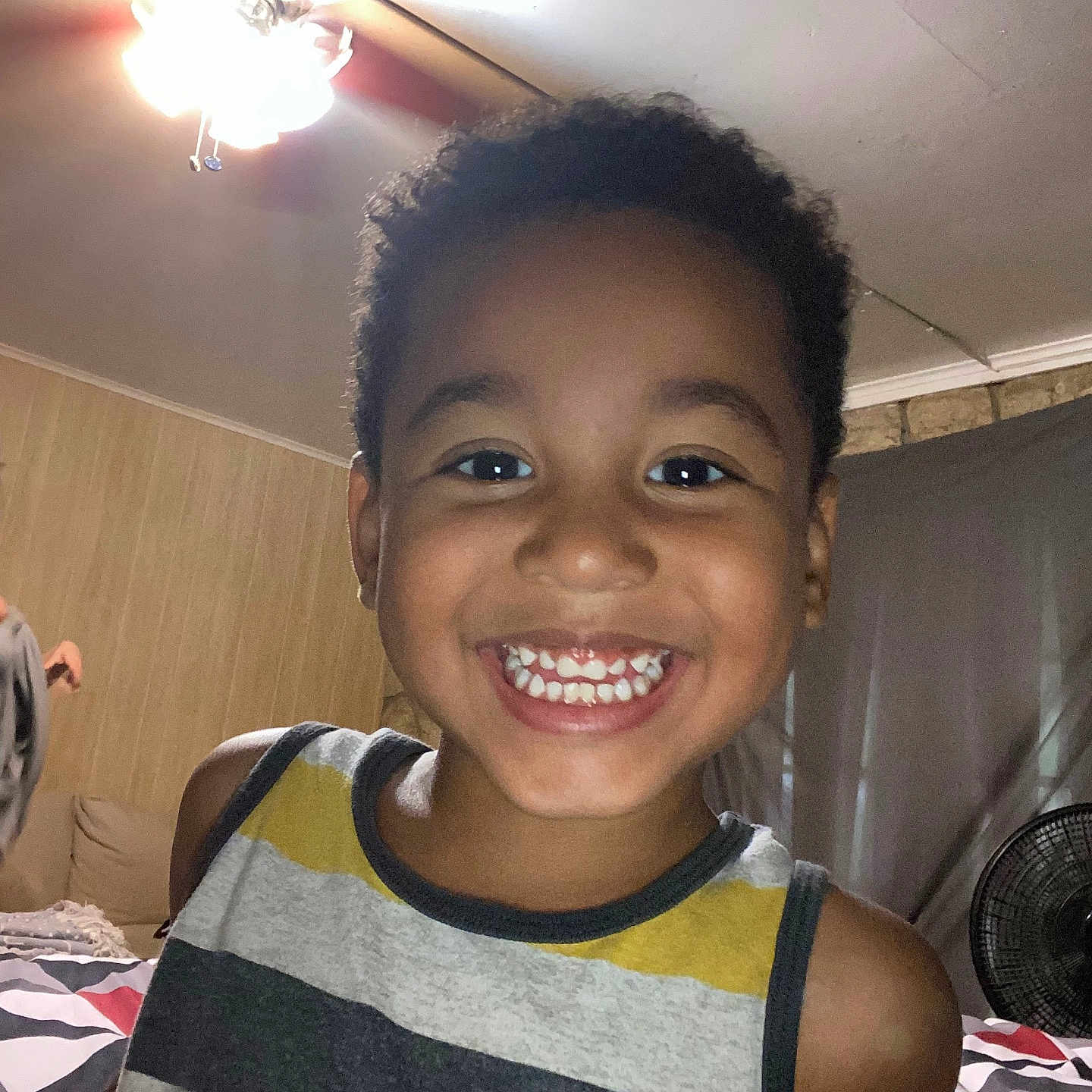 Devin is registered to the contest to win money with this photo: appliance, bodypart, ceilingfan, child, device, electricaldevice, face, female, girl, hair, happy, head, indoors, lighting, mouth, person, photography, portrait, smile, teeth