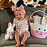 Sevaeh is registered to the contest to win money with this photo: baby, infant, smiling, headband, plush_toy, bunny, basket, books, toys, couch, blanket, patterned_blanket, pink, white, happy, child, indoor, cute, seated, portrait