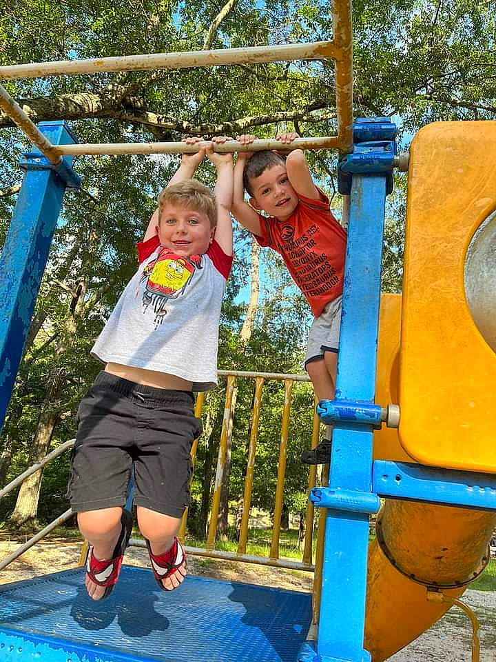 Kolby is registered to the contest to win money with this photo: blue, chute, city, clothing, fun, gas, happy, joy, leisure, outdoor_play_equipment, outdoor_recreation, people_in_nature, person, plant, playground, recreation, shorts, smile, t_shirt, toddler