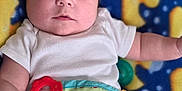 Michael joined the competition — help win amazing prizes! baby, infant, child, white_onesie, colorful_blanket, toy, teether, frog_toy, patterned_blanket, ducks, cute, face, lying_down, soft_toys, indoor, closeup, portrait, chubby_cheeks, curious, bright_eyes
