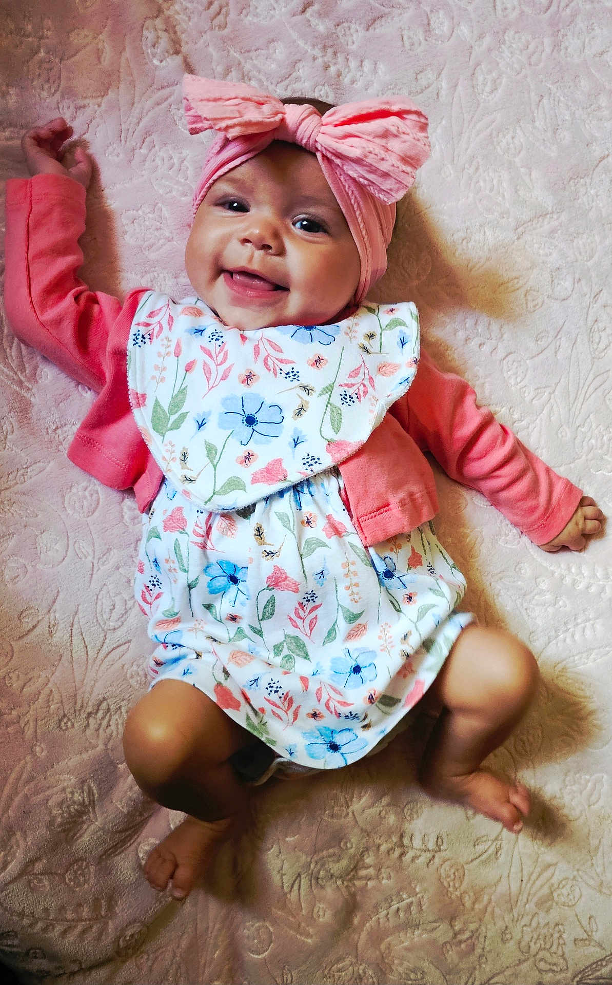 Caylin joined the competition — help win amazing prizes! baby, infant, smiling, pink_bow, headband, floral_outfit, lying_down, blanket, cute, happy, child, skin, face, small_hands, small_feet, indoors, portrait, baby_girl, fabric, soft_texture