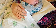 Waylon joined the competition — help win amazing prizes! adult, baby, blanket, care, closeup, comfort, cozy, cradle, elephant_pattern, fabric, hand, indoor, infant, pattern, person, protection, resting, sleeping, soft, warm