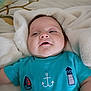 baby, infant, blanket, blue_shirt, nautical_symbols, anchor, lighthouse, lifebuoy, sailboat, face, cute, cozy, soft, child, clothing, lying_down, indoors, portrait, happy, smiling