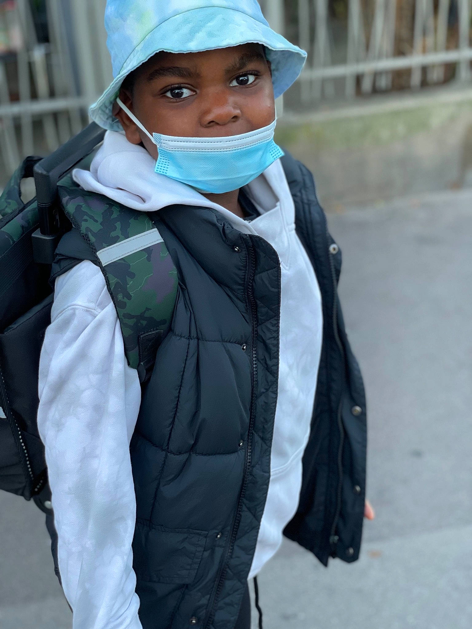 Keyron participe au concours pour gagner de l'argent avec cette photo : cap, child, costume, electric_blue, fashion_accessory, fashion_design, fence, formal_wear, glove, headgear, headwear, neck, outerwear, person, personal_protective_equipment, scarf, sleeve, street_fashion, top, tradition
