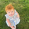 baby, child, grass, outdoor, blue_eyes, red_hair, dress, socks, smiling, sitting, sunlight, nature, happy, cute, person, footwear, greenery, playful, young, portrait