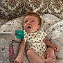 baby, infant, blanket, onesie, pacifier, clothing, lying_down, indoor, cute, child, newborn, face, hand, foot, soft_texture, patterned, relaxing, young, comfort, curious