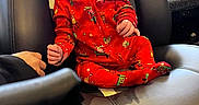 Aurora joined the competition — help win amazing prizes! baby, chair, child, curious, cute, expression, face, hands, head, holiday_theme, indoor, infant, patterned_clothing, person, plush, red_onesie, seat, skin, soft, stitching