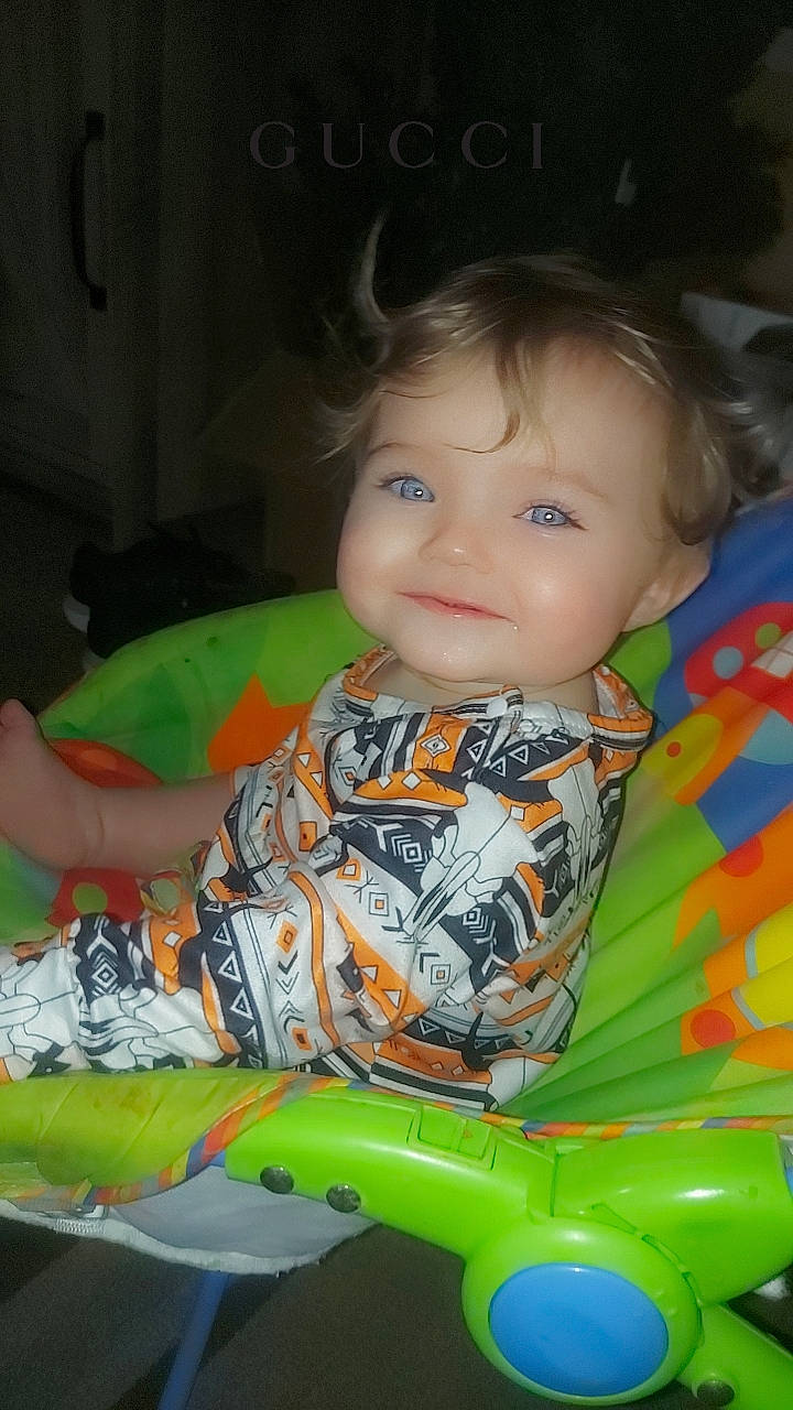 Coraline is registered to the contest to win money with this photo: baby, baby_products, baby_toys, cheek, child, fun, grass, happy, iris, joy, leisure, nose, person, play, sitting, skin, smile, t_shirt, toddler, toy