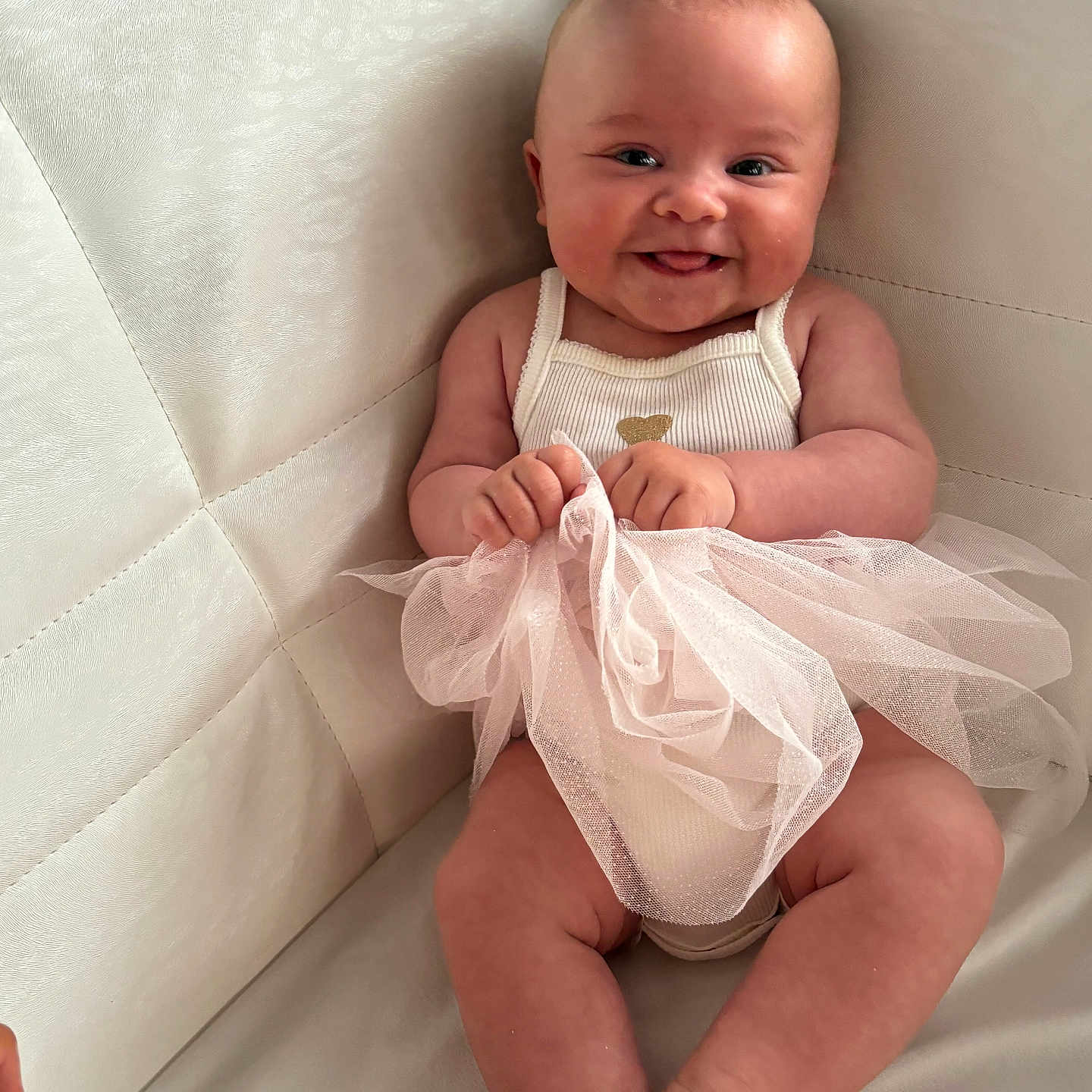 Djeursey participe au concours pour gagner de l'argent avec cette photo : baby, child, clothing, couch, cute, face, foot, furniture, hand, happy, indoor, infant, light, person, portrait, sitting, skin, smiling, texture, tutu