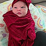 baby, blanket, child, colorful, couch, cute, eyes, face, headband, heart_pattern, indoors, infant, lying_down, newborn, portrait, rainbow, red_clothing, soft_texture, swaddle, wrapped
